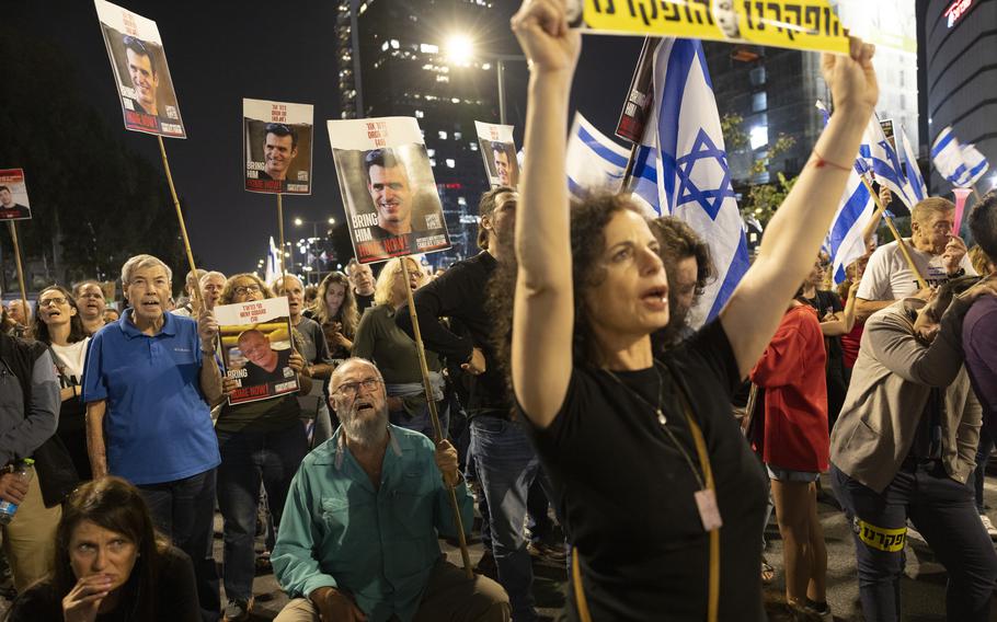 Yuval Or, 72, the father of hostage of Dror Or, sits on a folding chair in the middle of the road during an anti-government protest Saturday, April 20, 2024, in Tel Aviv.
