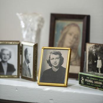 Family photos, including one of Flannery O’Connor, center, are among the artifacts at Andalusia Farm. The farm, where O’Connor wrote most of her books and short stories, is set on more than 500 bucolic acres near Milledgeville, Ga. 