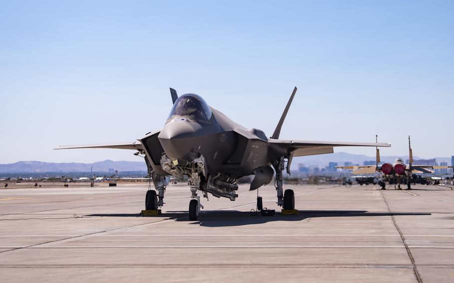 An F-35A Lighting II carrying a non-nuclear mock B61-12 bomb sits on the flight line at Nellis Air Force Base, Nev., Sept. 21, 2021. Two F-35A jets dropped the mock bombs in a demonstration that keeps the aircraft on track to be certified for nuclear deterrence missions, Air Force officials said.
