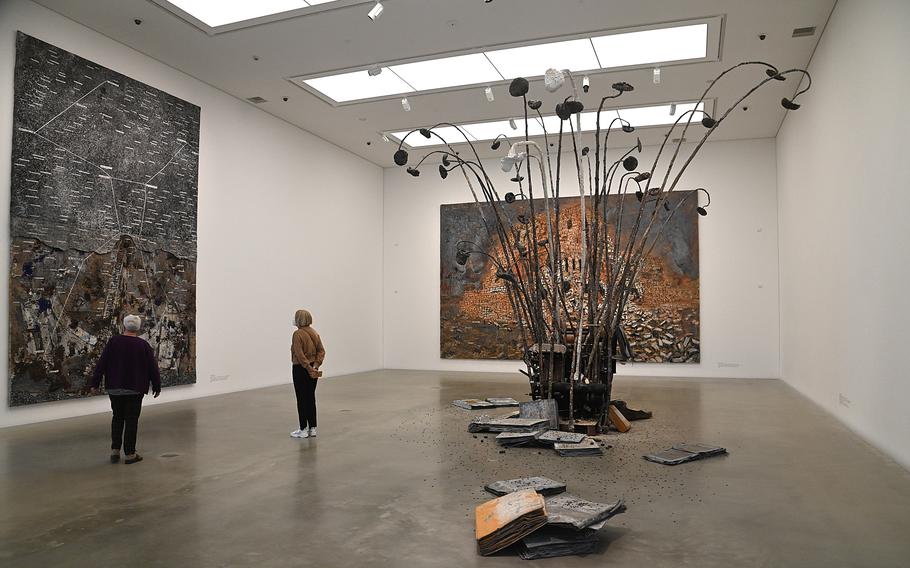 Vistitors to the Kunsthalle Mannheim look at Anselm Kiefer’s Jaipur, a mixed media work from 2005. On the rear wall is his The Fertile Crescent, in the foreground is his sculpture The Lost Letter. Kiefer is one of Germany’s leading contemporary artists.