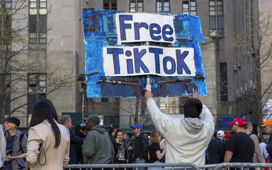 A man carries a Free TikTok sign in front of the courthouse where the hush-money trial of Donald Trump got underway April 15, 2024, in New York. President Joe Biden on Wednesday signed a law that would ban Chinese-owned TikTok unless it is sold within a year.