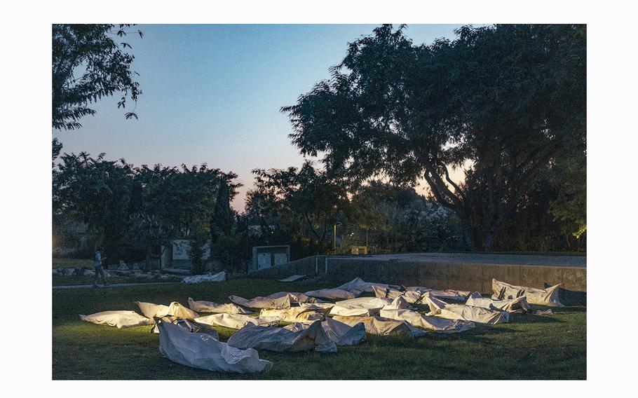 Bodies of Hamas militants are covered and lined up in a park in Kibbutz Beeri, Israel, on Oct. 11, 2023
