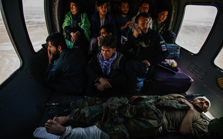 Hosy Andar, deputy governor of Ghazni province, top left, and soldiers, some wounded, are transported from at an outpost in Ghazni Province to Kabul Airbase in Afghanistan. Taliban road closures mean nearly all logistical support to thousands of outposts, including resupplies of ammunition and food, must be done by air. 