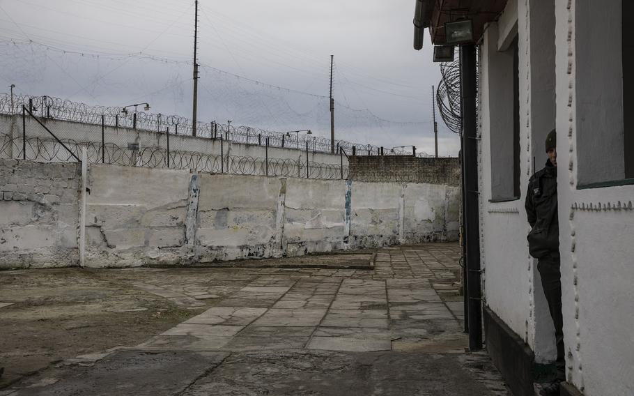 A Ukrainian guard at a detention camp where Russian prisoners of war are kept in western Ukraine.