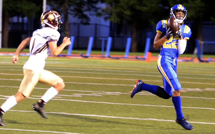 Yokota's Damian Abrams hauls in a 50-yard pass ahead of Matthew C. Perry's Jordan Wooten.