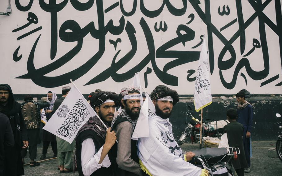 Taliban militants celebrate in the square in front of the U.S. Embassy in Kabul on Monday. One year earlier, after a chaotic withdrawal by the United States, the group swept into the Afghan capital and completed its takeover of the country, ending a long, brutal war and upending the lives of millions.