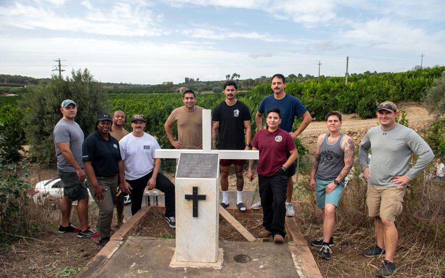 Naval Air Station Sigonella Seabees stand beside a traffic crash memorial in Sicily that they restored Nov. 3, 2023.