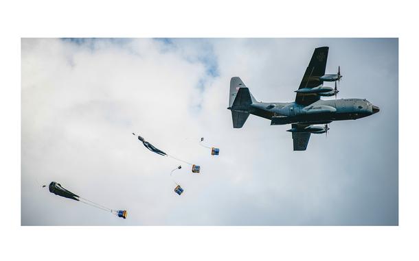 A U.S. military C-130 Hercules aircraft drops humanitarian aid over Serbia as part of an exercise on Sept. 16, 2021.