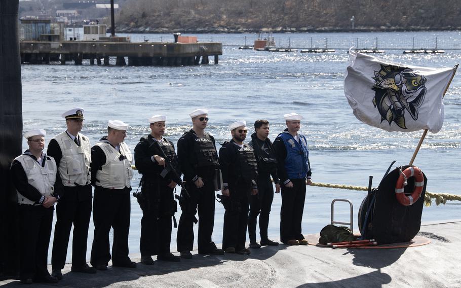 Sailors stand atop the USS Indiana as it prepares to moor.