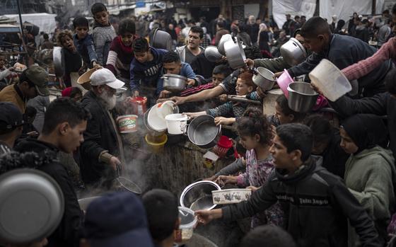 Palestinians line up for a meal in Rafah, Gaza Strip, on Dec. 21, 2023.