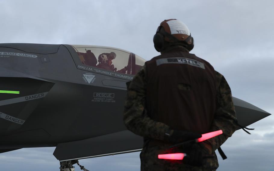 A Marine stands by to communication with a pilot of an F-35B Lightning II attached to Marine Operational Test and Evaluation Squadron (VMX) 1 on the flight deck aboard amphibious assault ship USS Tripoli (LHA 7), Jan. 19. Tripoli is underway conducting routine operations in U.S. 3rd Fleet.