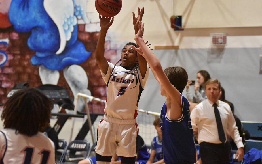 Aviano's Deon Walker shoots before Rota's Hampton Brasfield can get close enough in the Saints' 51-40 victory over the Admirals on Friday, Dec. 9, 2022, in Aviano, Italy.