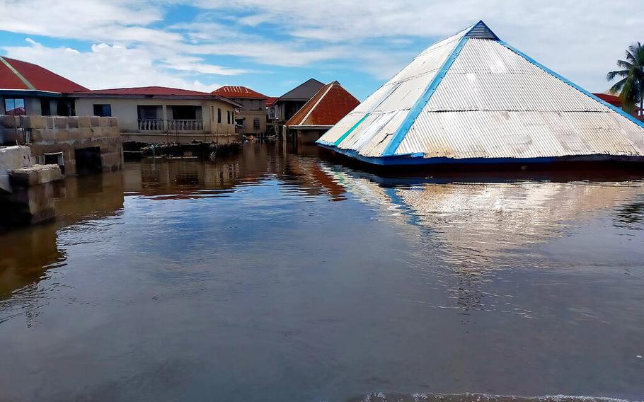 A flooded street and partially submerged houses are seen in Anambra Nigeria, on Oct. 7, 2022. 