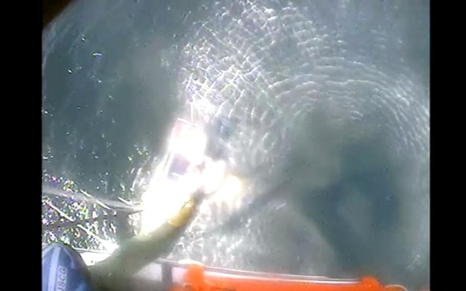 A Coast Guard Air Station New Orleans MH-65 Dolphin helicopter rescues a mariner from a sailing vessel taking on water Dec. 6, 2021, near Grand Isle, La. The helicopter crew arrived on scene, safely hoisted the mariner, and took him to Harry P. Williams Memorial Airport in Patterson, La., with no reported injuries.