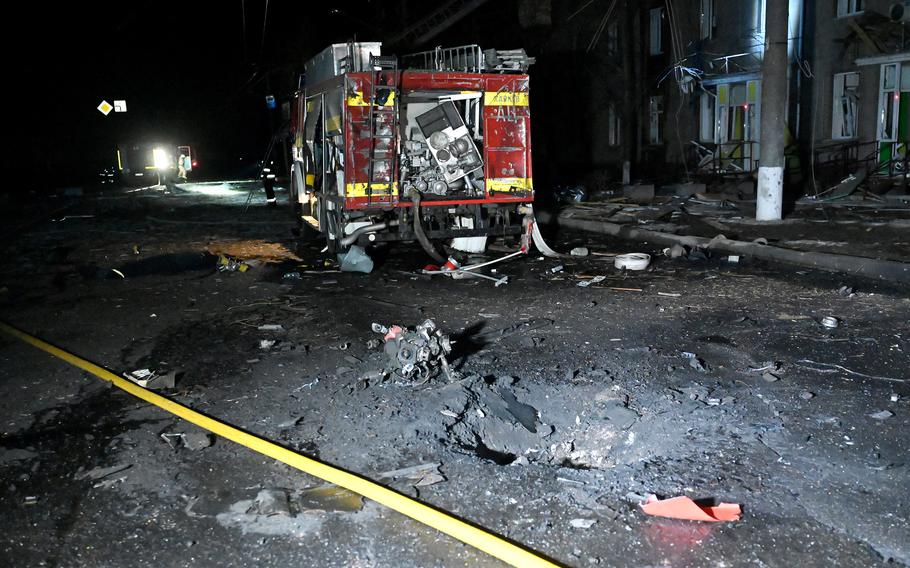 A crater sits next to a damaged emergency vehicle following a drone attack in Kharkiv, on April 4, 2024, amid the ongoing Russian-Ukrainian conflict. 