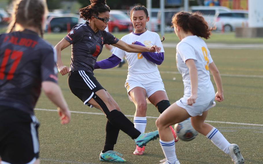 Nile C. Kinnick's Jaylah Petty and Yokota's Mariah Hilliard and Vitalia Duran scramble for the ball during Wednesday's DODEA-Japan girls soccer match. The Red Devils won 4-1.