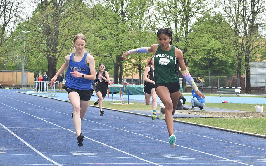 Naples' Abigail Michienzi beats Rota's Sophia Dickkut to the finish line in a heat of the girls' 100-meter dash Saturday, April 23, 2022, in Pordenone, Italy. Both had busy days on the track with Dickkut also finishing first in the 400 and second in the 200 and Michienzi winning the 300 hurdles, anchoring the 4x100 relay team to a win and finishing second in the 800.