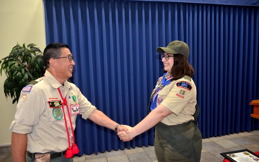 Lillian Vogel, right, shakes hands with Troop 13 Scoutmaster Yutaka Sugiyama after Vogel’s Eagle Scout ceremony at Yokosuka Naval Base, Japan, on June 28, 2022. 