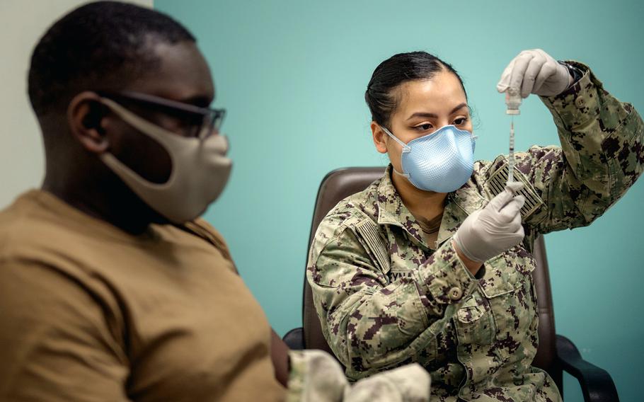 Petty Officer 2nd Class Amanda Reyna prepares to administer a COVID-19 vaccine in spring 2021 in Bahrain. 