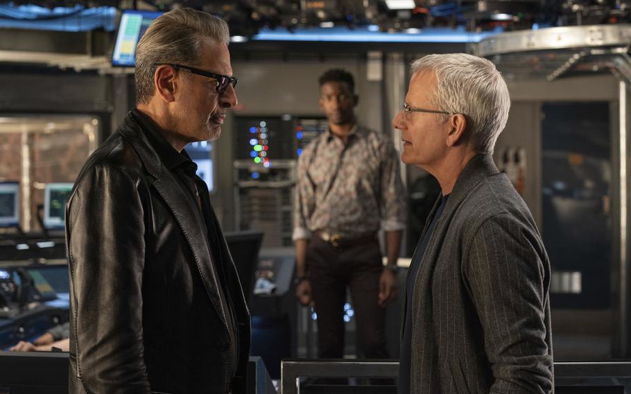 Jeff Goldblum as Dr. Ian Malcolm, left, and, Campbell Scott as Lewis Dodgson in a scene from “Jurassic World Dominion.”  Scott portrays a biotech company CEO responsible for unleashing a genetically enhanced breed of grasshopper that devastates crops. 