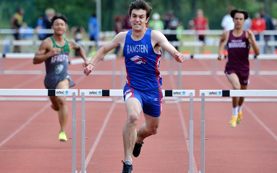 Ramstein’s Vincent Studer celebrates as he heads to the finish line after clearing the final hurdle in the 300-meter hurdles race at the DODEA-Europe track and field championships in Kaiserslautern, Germany, May 20, 2023. He won in 40.79 seconds.