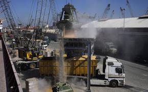 Trucks being filled with Ukrainian corn from the ship AK Ambition, sailing under the flag of Panama at Tripoli seaport, in Tripoli, north Lebanon, Monday, Sept. 26, 2022. 