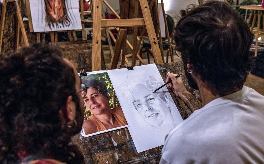 Tal Simon, 29, works from a photograph to sketch a portrait of Yasmin Bira, who was killed in the Hamas Oct. 7, 2023, attack. 