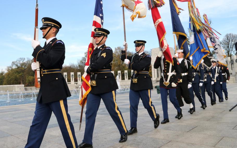 The Armed Forces Color Guard departs after the playing of the national anthem during Veterans Day ceremony at the National World War II Memorial in Washington, D.C., November 11, 2023.