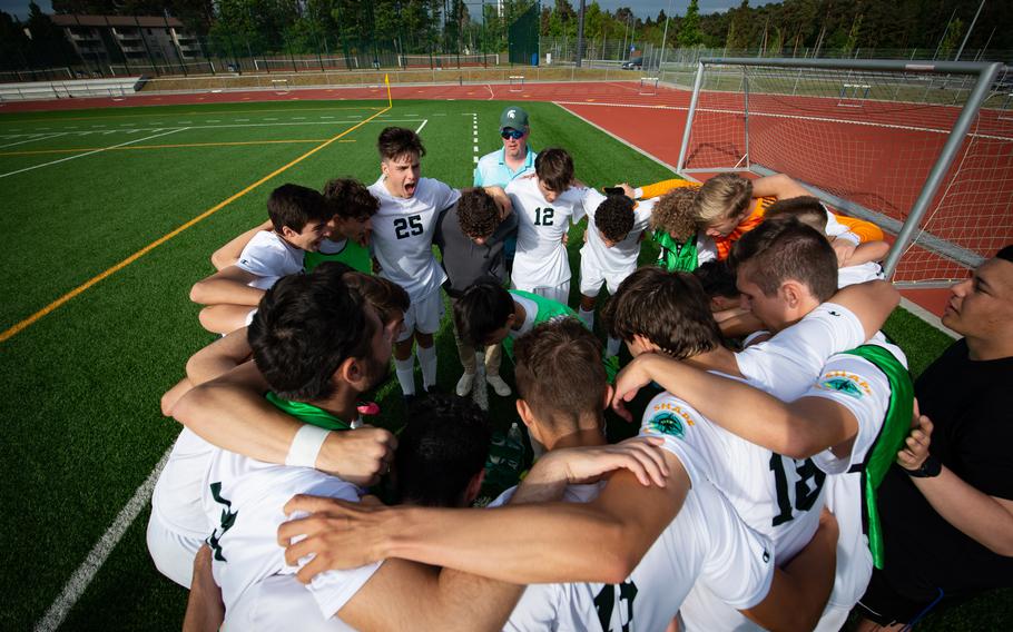 Players and coaches of Division-I Team SHAPE, of the Supreme Headquarters Allied Powers Europe, gather for a half-time huddle during their game against Wiesbaden during the DODEA-Europe Soccer Championships at Ramstein Air Base, Germany, May 16, 2022. While playing a strong defense in the first half of the game, the team from Belgium lost ground against Wiesbaden, losing 3-2.