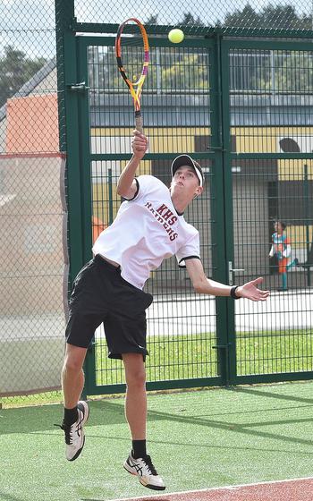Raider Jace Martin serves during a singles match against Ansbach's Bobby Lovello on Sept. 23, 2023, at Kaiserslautern High School in Kaiserslautern, Germany.