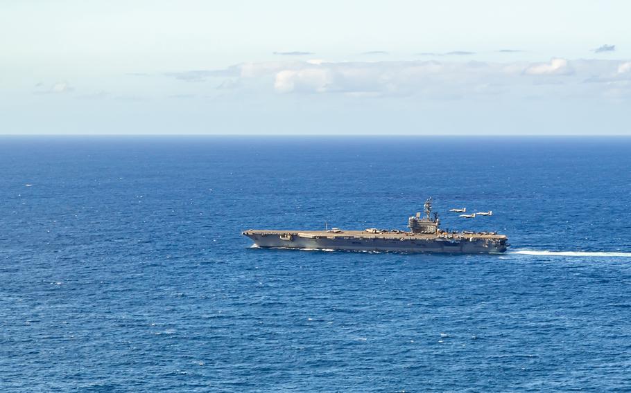 Three F-18 Super Hornets, piloted by Capt. Patrick Corrigan, Capt. Michael Sweeney and Rear Adm. Pat Hannifin, fly over the USS Ronald Reagan during Carrier Air Wing 5's change-of-command ceremony, July 14, 2023. 