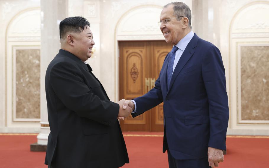 North Korean leader Kim Jong Un, left, and Russian Foreign Minister Sergey Lavrov greet each other