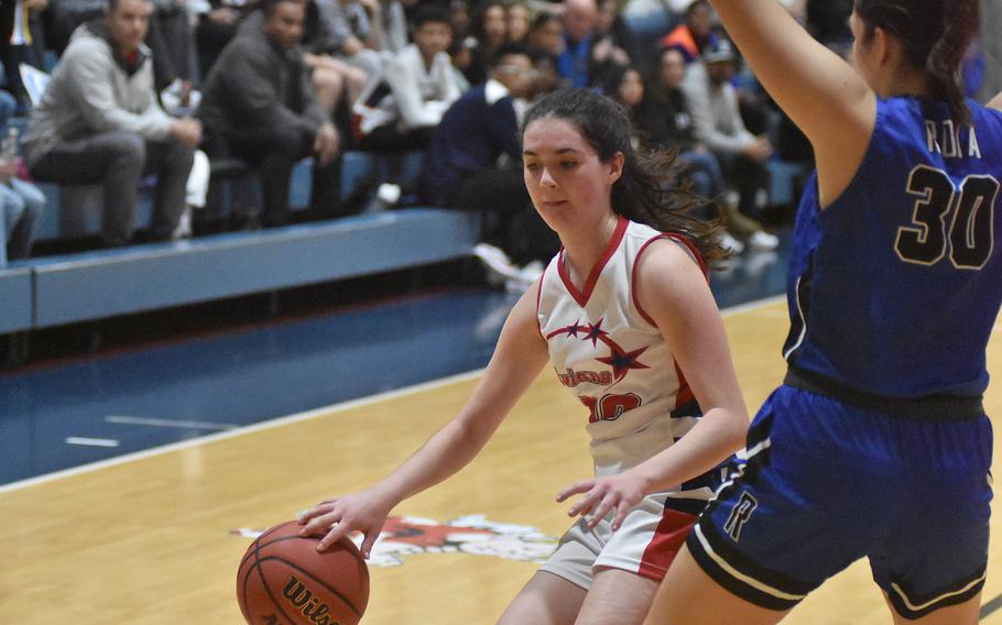 Aviano's Grace O'Connor tries to get by Rota's Maddie Lewis in the Saints' 30-16 victory over the Admiirals on Friday, Dec. 9, 2022 in Aviano, Italy.