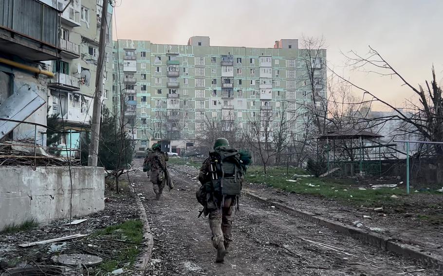 Members of the 251st battalion head to their position at first light in Bakhmut, Ukraine.