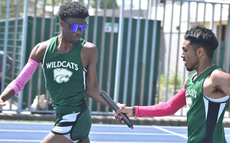 Naples' Chris White, left, and Jon Castro-Cruz struggled with the last handoff, but the Naples Wildcats still easily won the boys 4x100 relay Saturday, April 29, 2023, at a DODEA-Europe track meet in Pordenone, Italy.