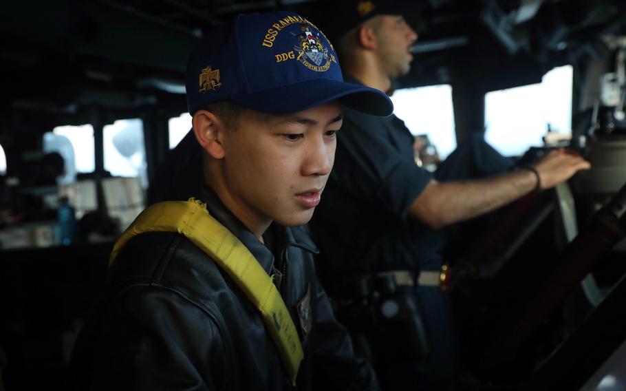 Lt. j.g. Bryan Nguyen stands watch on the bridge of the guided-missile destroyer USS Rafael Peralta in the Taiwan Strait, Thursday, Nov. 2, 2023.