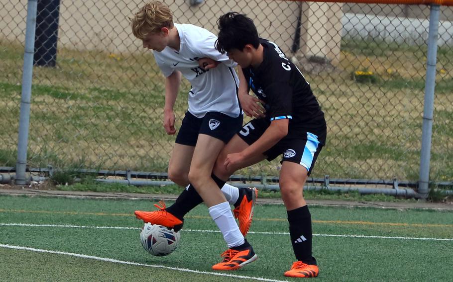 Korea International’s Thijs Kruisman and Osan’s Cannon DiSanto battle for the ball during Saturday’s Korea boys soccer match. The Phoenix won 3-0.