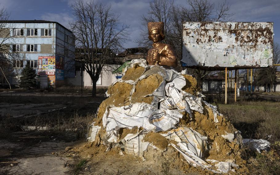 In Huliaipole, sandbags are piled around a statue of Nestor Makhno to protect it from shelling. 
