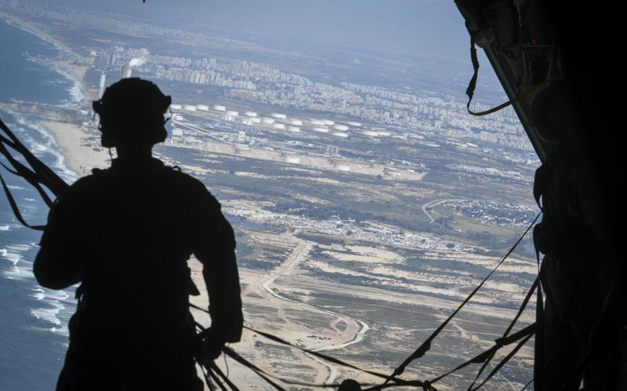 An airman looks out over the Mediterranean Sea during an airdrop of humanitarian aid from a U.S. Air Force C-130 cargo plane into northern Gaza on Wednesday, March 20, 2024.