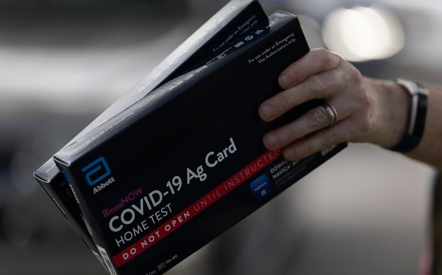 COVID-19 at-home rapid test kits are given away during a drive-thru event at the Hollywood library on Dec. 30, 2021, in Hollywood, Florida. 