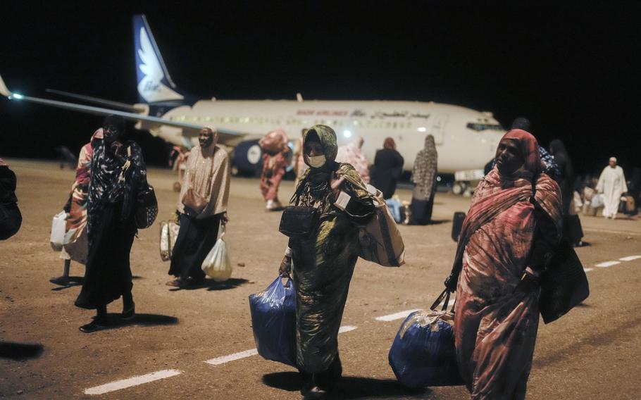 People from Sudan, who had been stranded in Jeddah, Saudi Arabia, arrive at Port Sudan airport, Thursday, May 11, 2023. 