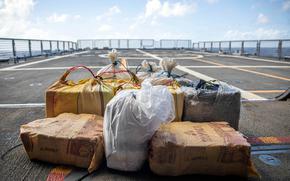 Nearly 700 pounds of suspected cocaine seized by the USS Milwaukee and Coast Guard law enforcement agents sits on the ship's flight deck Jan. 7, 2022. The seizure was made in the Caribbean Sea.