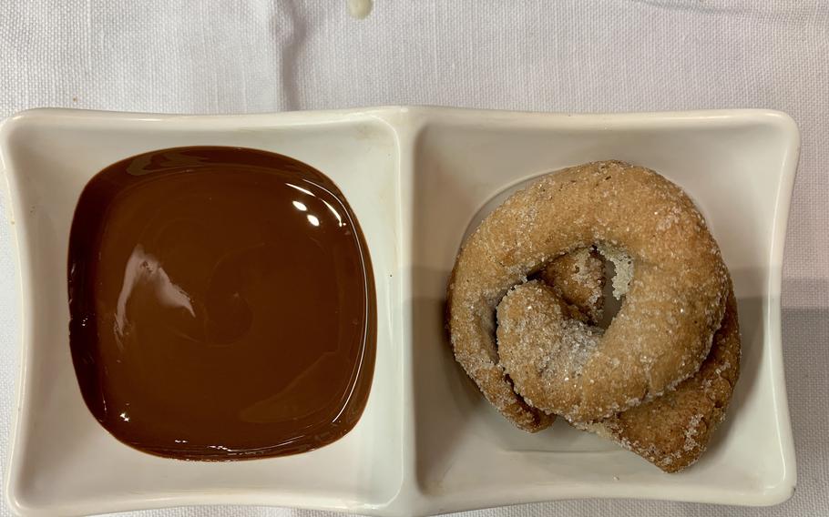 Patrons who don’t order dessert receive house-baked cookies and warm chocolate sauce as a treat at Roscioli in Rome.