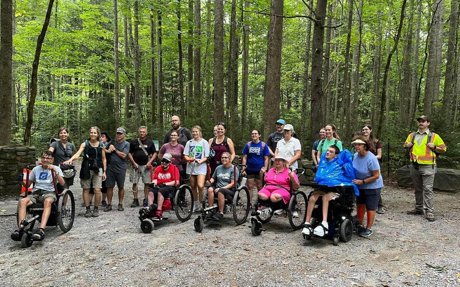 Participants attend a hike in Great Smoky Mountains National Park using the GRIT Freedom Chair on loan from Catalyst Sports.