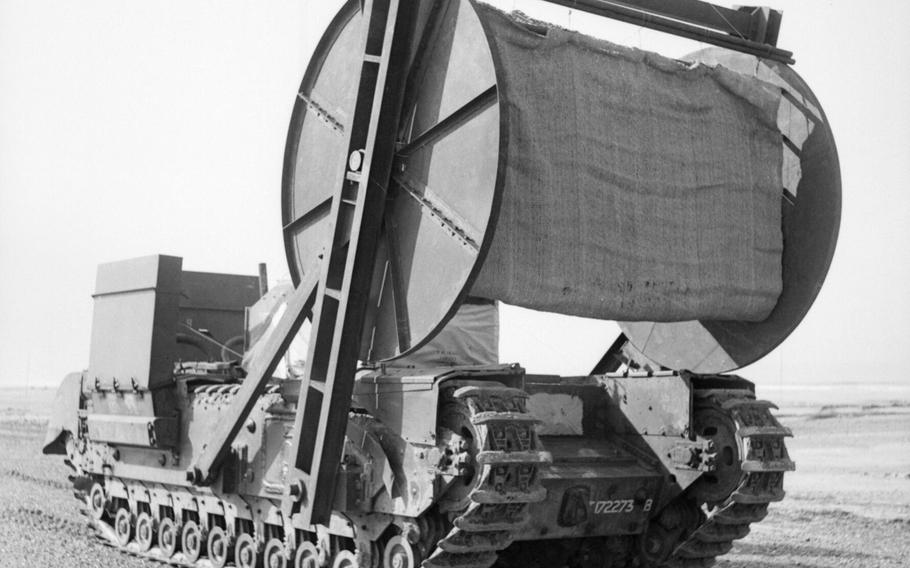 A black and white photo of a tank equiped with a mechanism to lay out canvas for other tanks to drive over 