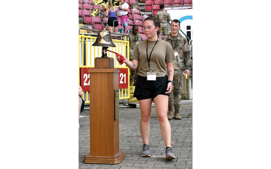 Senior Airman Breanna Hathaway of the 721st Aircraft Maintenance Squadron rings the bell as she finishes the 9/11 Stair Climb on Sept. 11, 2023, at Fritz Walter Stadium in Kaiserslautern, Germany. Participants went up and down 68 stairs 30 times to equal the number of steps it took to get to the top of the World Trade Center's twin towers.