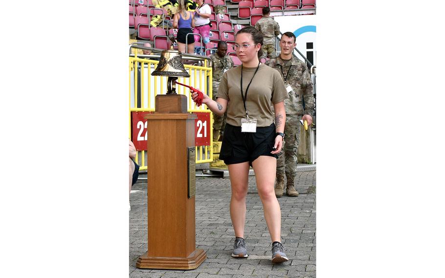 Senior Airman Breanna Hathaway of the 721st Aircraft Maintenance Squadron rings the bell as she finishes the 9/11 Stair Climb on Sept. 11, 2023, at Fritz Walter Stadium in Kaiserslautern, Germany. Participants went up and down 68 stairs 30 times to equal the number of steps it took to get to the top of the World Trade Center's twin towers.
