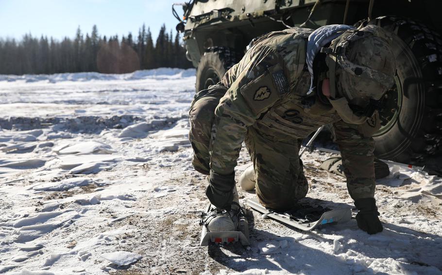 Army Sgt. Ricardo Rodriguez, assigned to the 3rd Battalion, 21st Infantry Regiment, straps on snowshoes to conduct dismounted patrol at Fort Greely, Alaska, March 14, 2022, during the Joint Pacific Multinational Readiness Center exercise.
