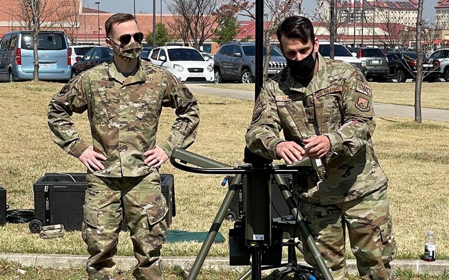 Airmen with the 607th Combat Weather Squadron show off their TMQ-53, a portable weather station, recently at Camp Humphreys, South Korea.