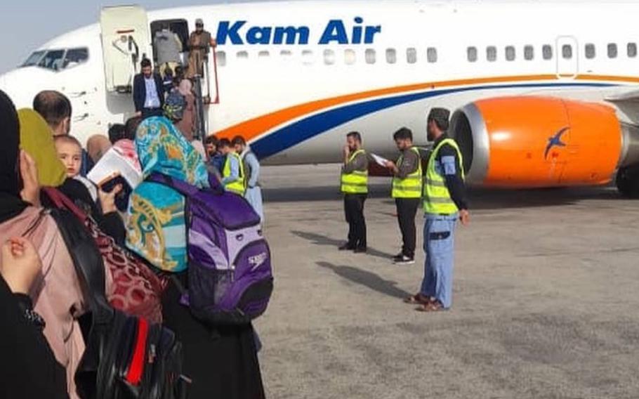 Evacuees wait to board a flight chartered by private U.S. group Argo that will take them out of Afghanistan, weeks after the U.S. airlift of more than 124,000 people ended in August. Argo wants the U.S. government to help fund the evacuation efforts, which, as of mid-October, were supported by donations.